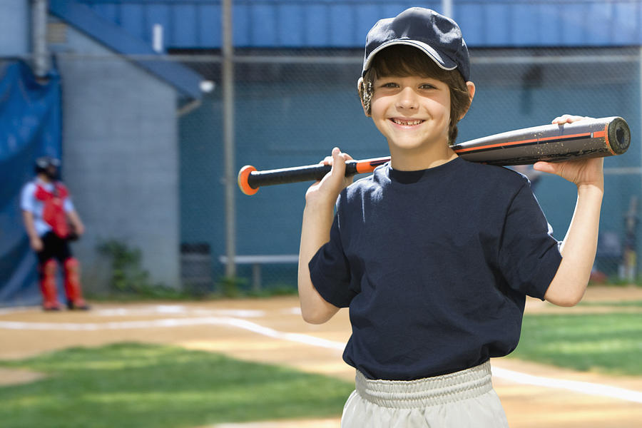 Caucasian boy holding baseball bat on field Photograph by Jose Luis Pelaez Inc