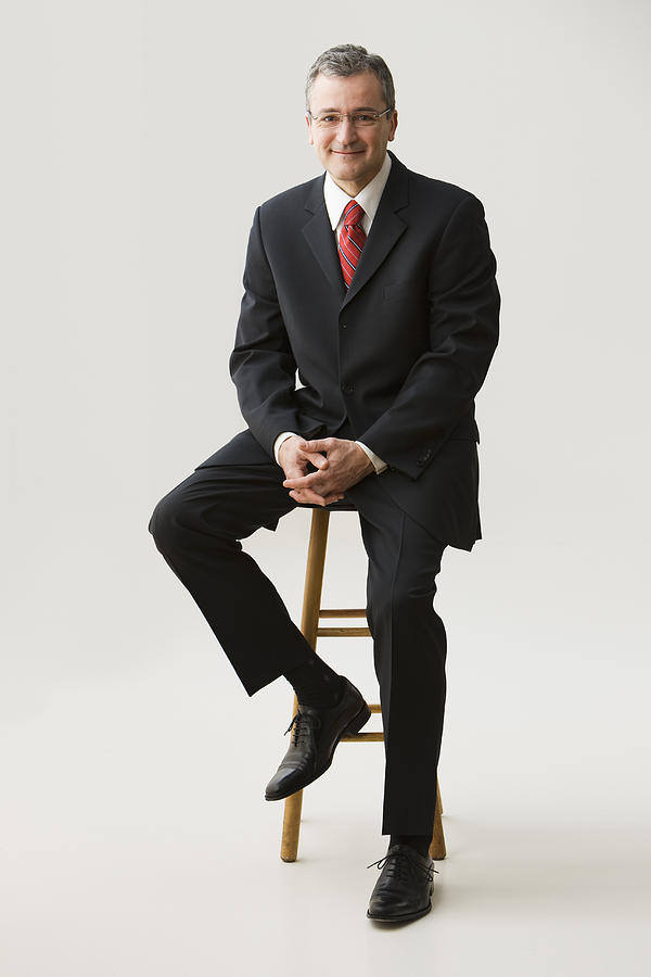 Caucasian businessman sitting on stool Photograph by Jose Luis Pelaez Inc