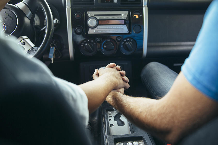 Caucasian couple holding hands in car Photograph by Inti St Clair