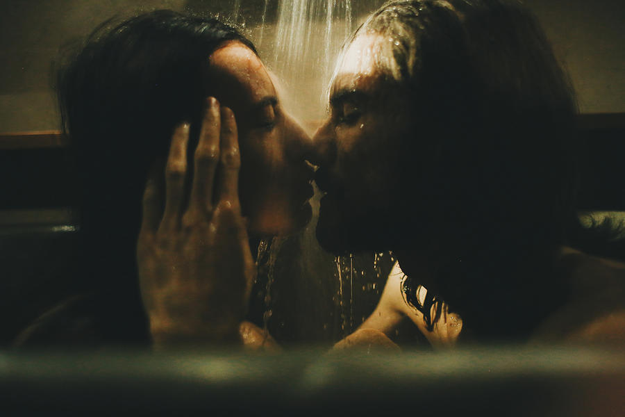 Caucasian couple relaxing in bathtub under shower Photograph by Sophie Filippova