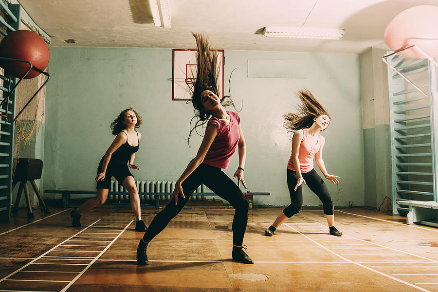 Caucasian dancers rehearsing in gym Photograph by Aleksander Rubtsov