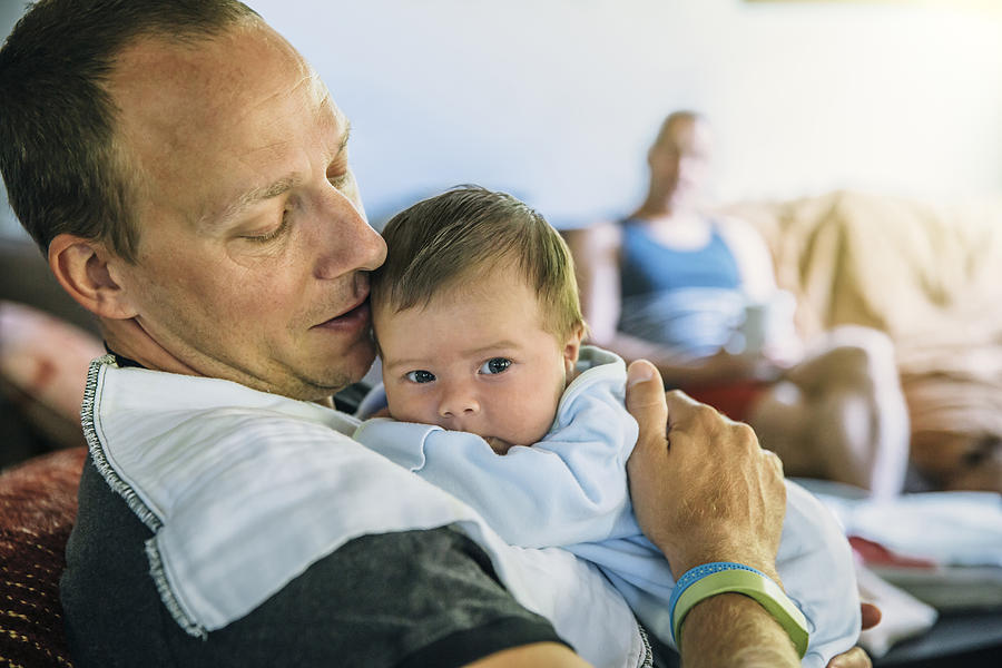 Caucasian father burping baby boy in living room Photograph by Inti St Clair