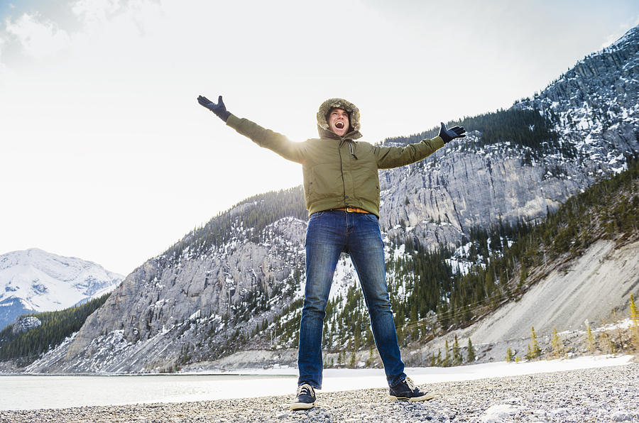 Caucasian man cheering in snowy field Photograph by Jacobs Stock Photography Ltd