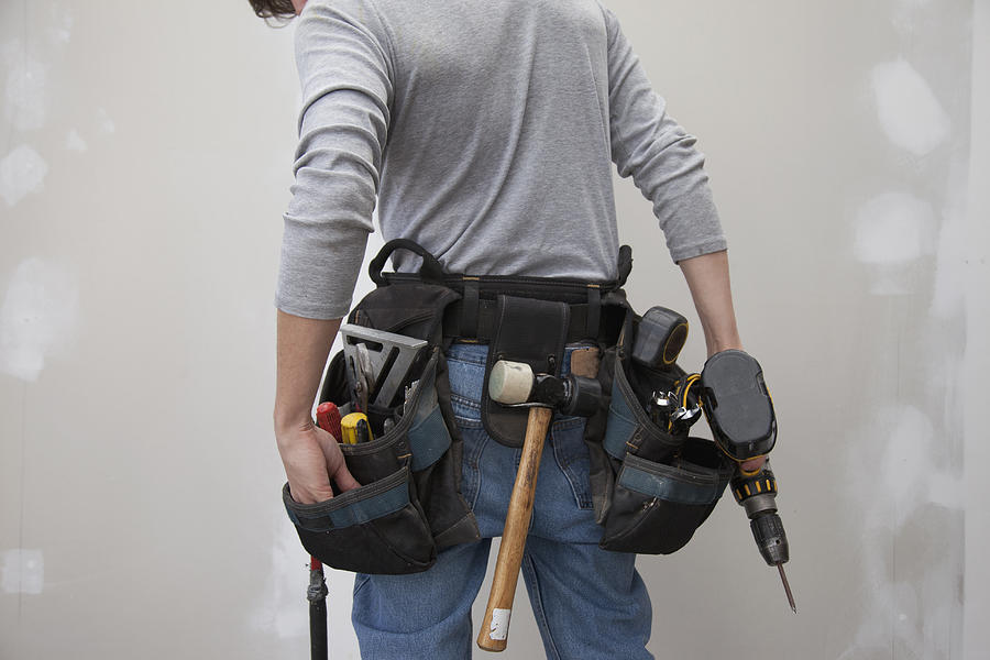 Caucasian man wearing tool belt Photograph by Hill Street Studios