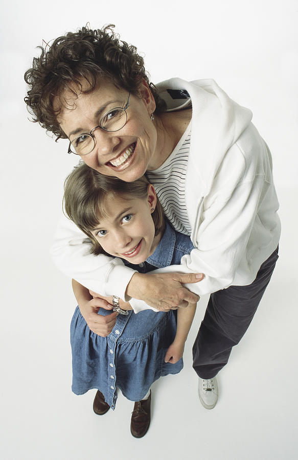 Caucasian Mom/grandma With Glasses Has Arm Around Her Girl And Leans Over Her Smiling Photograph by Photodisc