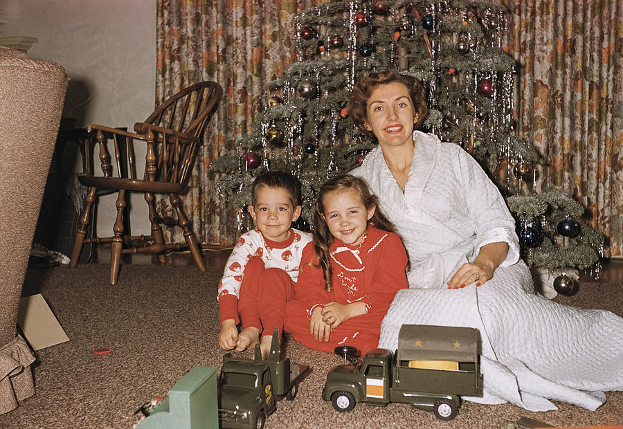 Caucasian mother posing with son and daughter near Christmas tree Photograph by PBNJ Productions