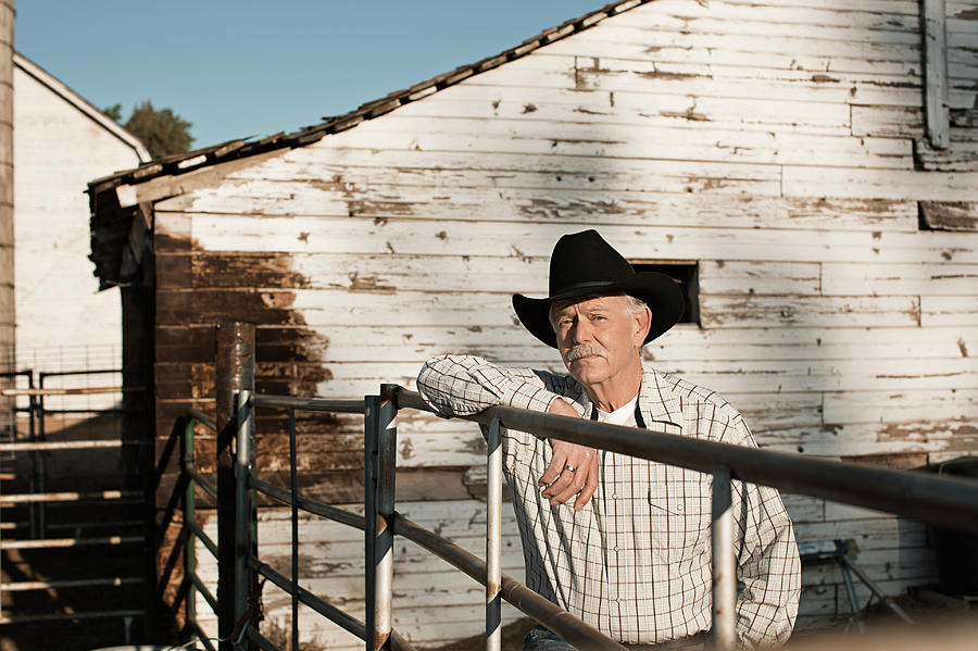 Caucasian Rancher Standing At Gate Photograph by Hill Street Studios