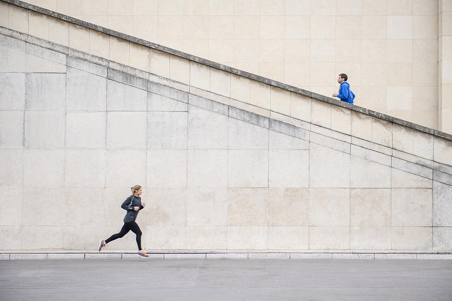 Caucasian runners jogging near staircase Photograph by Jacobs Stock Photography Ltd