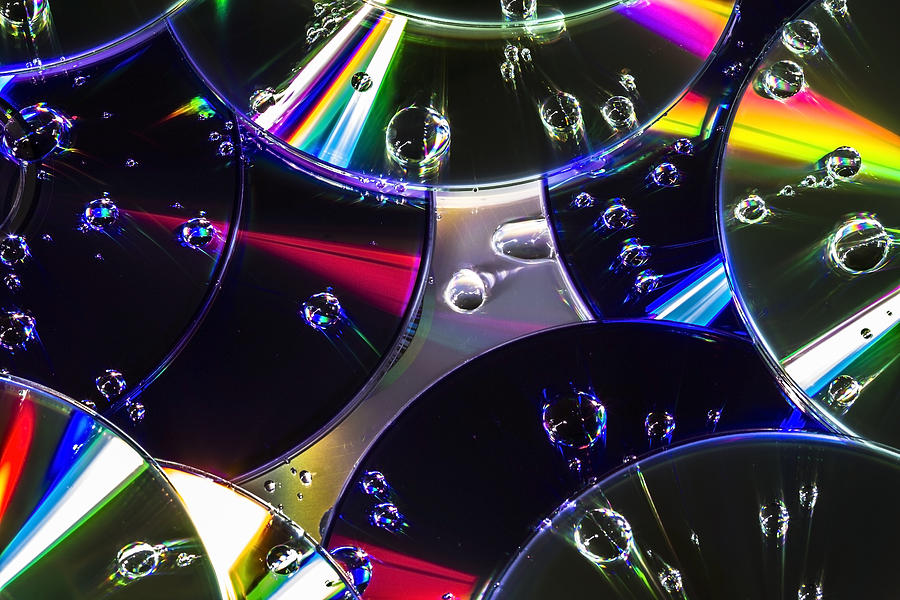 Cds And Water Drops Photograph by Sven Brogren