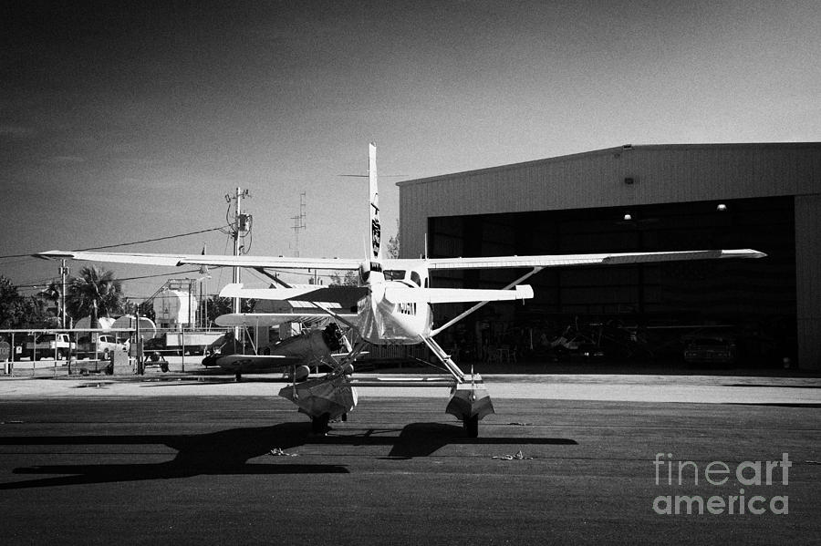 Key Photograph - Cessna U206g Fixed Wing Single Engine Seaplane In Front Of Hangar Key West International Airport Flo by Joe Fox