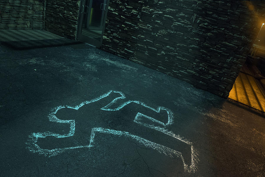 Chalk outline of body of victim on pavement Photograph by Kirk Marsh