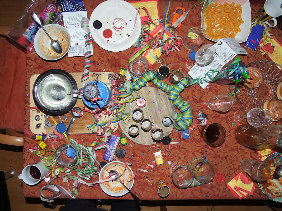 Chaos on table top after New Years Eve party Photograph by Lothar Knopp