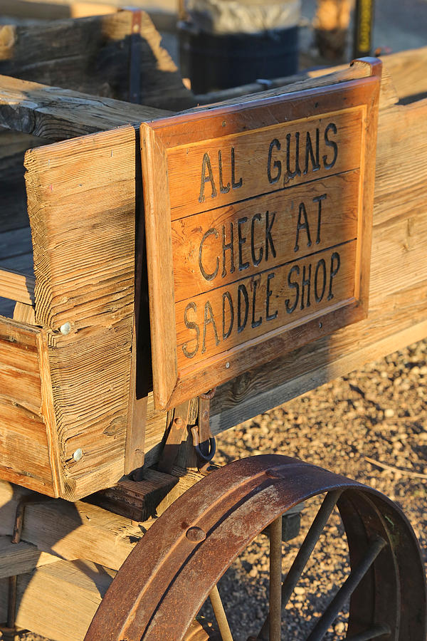 Check Guns at Saddle Shop Photograph by Michael Hope