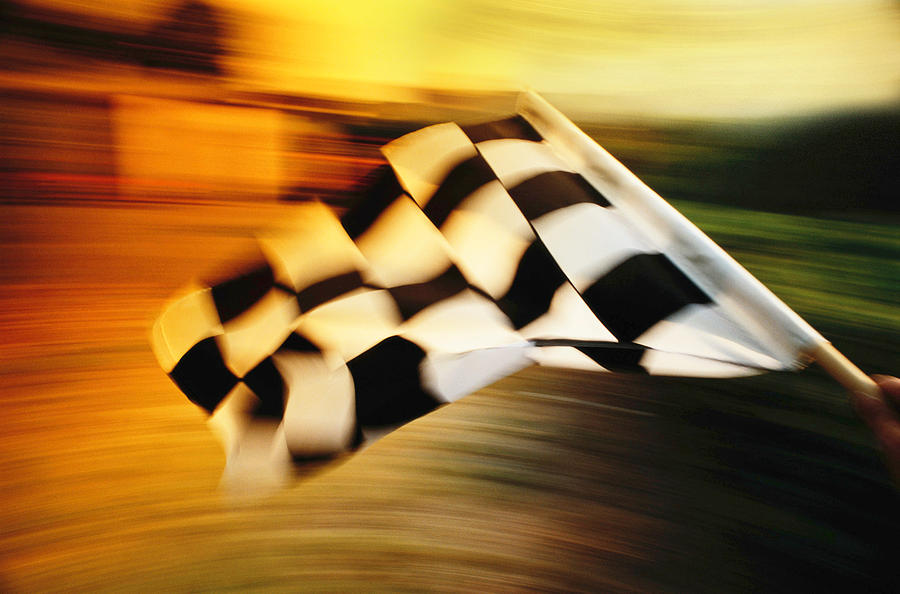Checkered flag waving at an car race. Photograph by Stevecoleimages