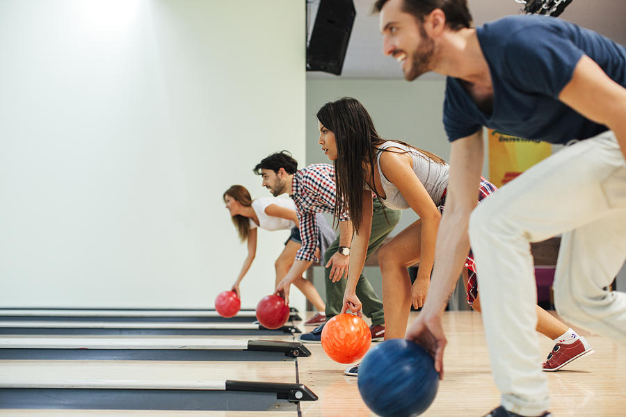 Cheerful Friends Bowling Together. Photograph by Vgajic