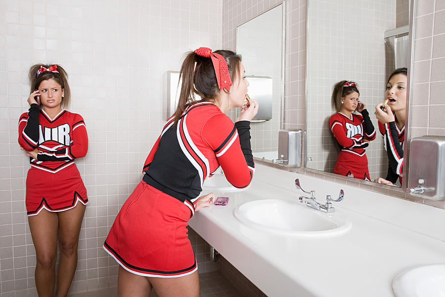 Cheerleaders in restroom Photograph by Image Source