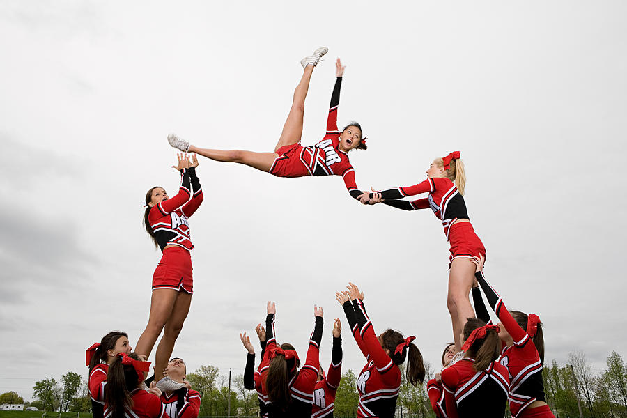 Cheerleaders performing routine Photograph by Image Source