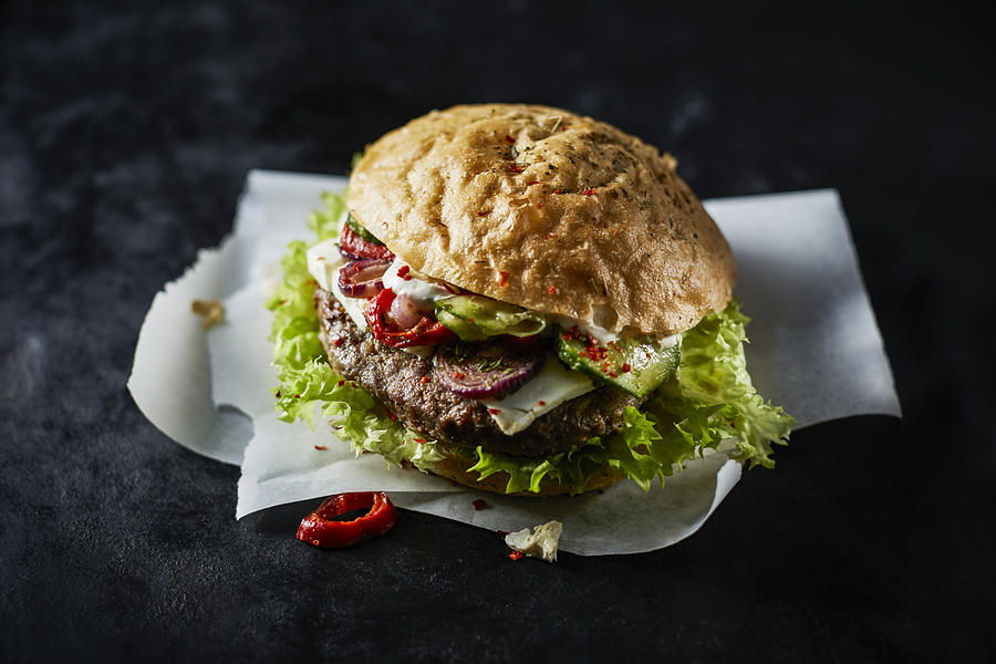 Cheeseburger on greaseproof paper Photograph by Westend61