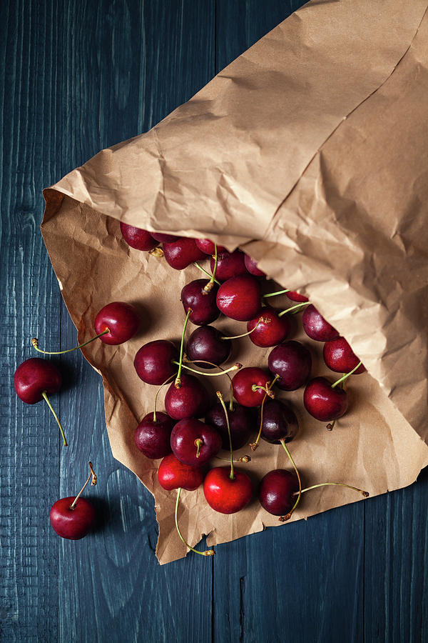 Cherries In Brown Paper, Close Up Photograph by Westend61