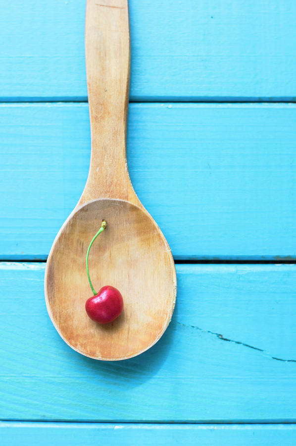 Cherry In A  Wooden Spoon Photograph by C.aranega