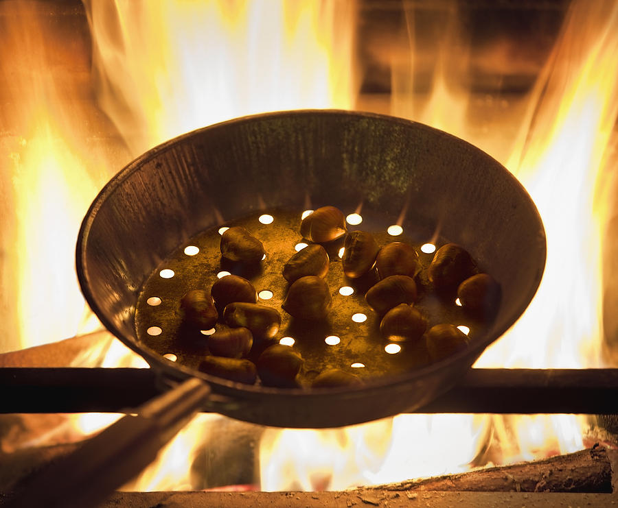 Chestnuts roasting in a pan on fire Photograph by Chris Ryan