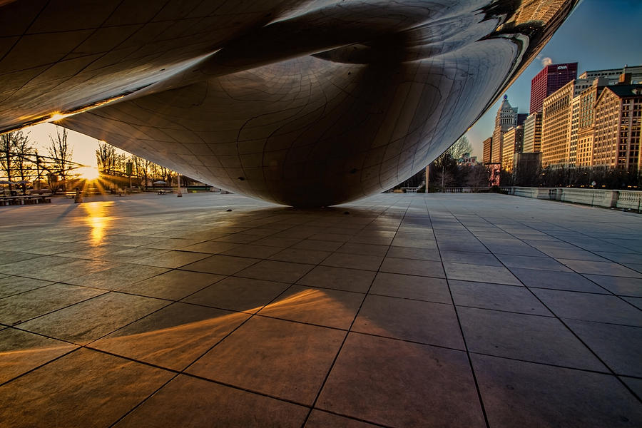 Chicagos cloudgate just as the sun appears over the horizon Photograph by Sven Brogren