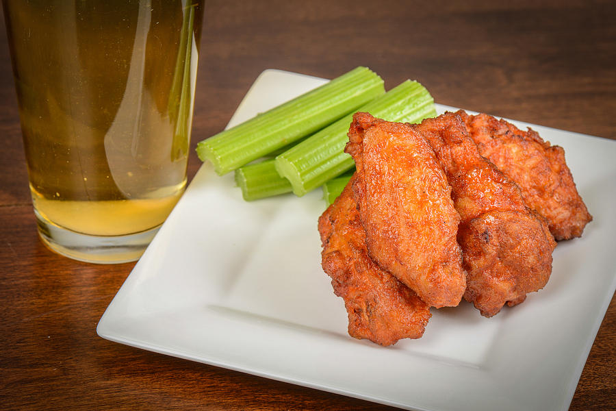 Chicken Buffalo Wings with Celery Sticks and Beer Photograph by Brandon Bourdages