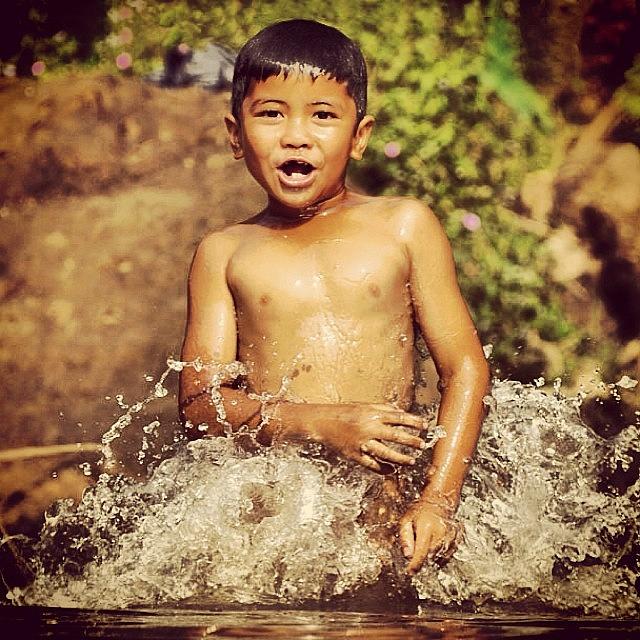 Nature Photograph - Child From Village #splash #child by Dani Daniar
