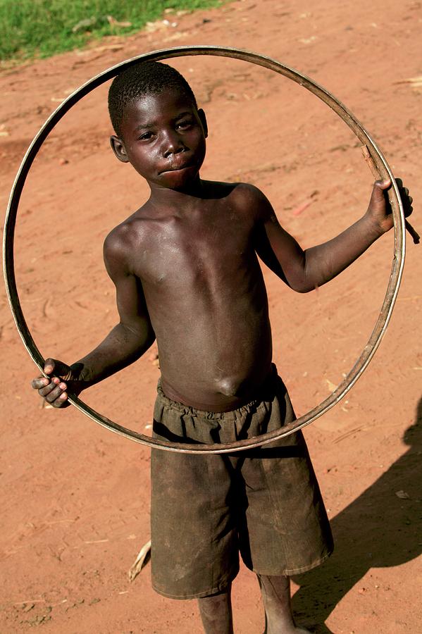 Toy Photograph - Child Playing With A Hoop by Mauro Fermariello/science Photo Library