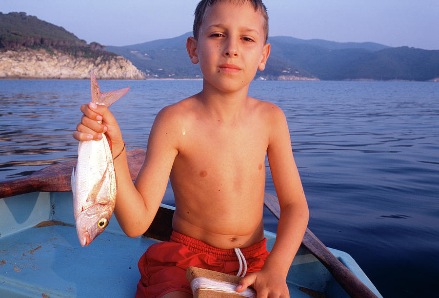 Child With Fish Photograph by Mauro Fermariello/science Photo Library