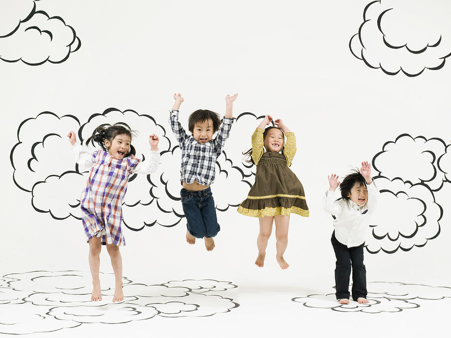Children Jumping  On The Clouds Photograph by Michael H