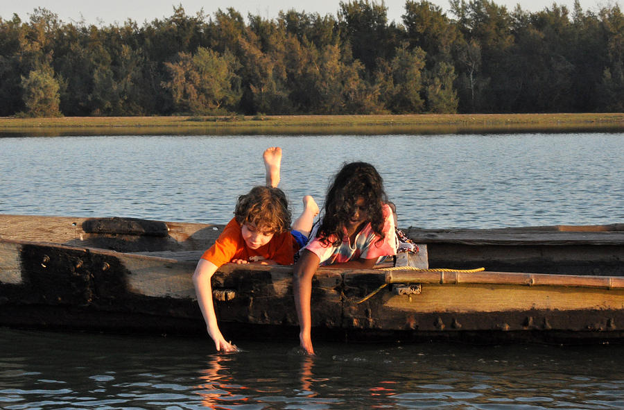 Children on a boat at sunset Chilika Lake India Photograph by Diane Lent