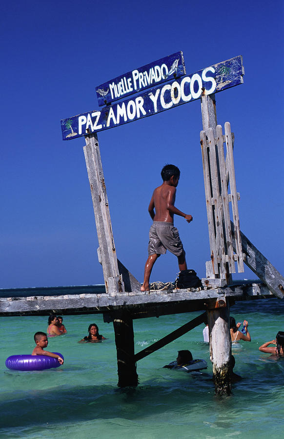 Children Play On Jetty Pas Amor Y Cocos Photograph by Dallas Stribley