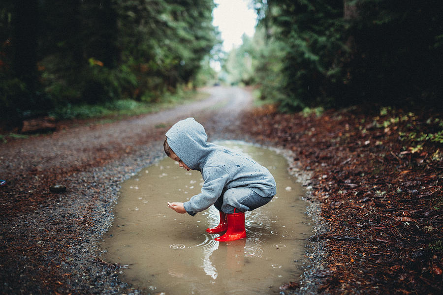 Children Playing in Rain Puddle Photograph by RyanJLane