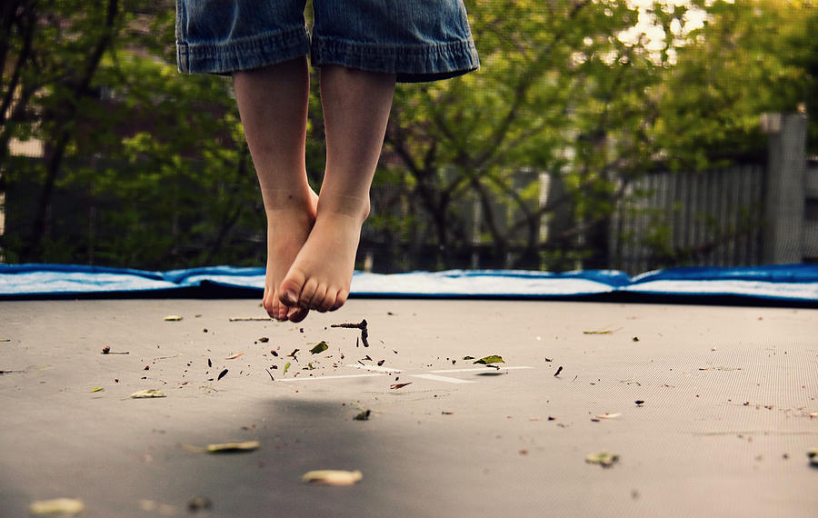 Childs dirty feet  jumping on trampoline Photograph by Ambre Haller
