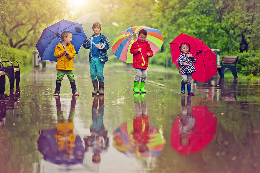 Chilren under umbrella Photograph by ArtMarie