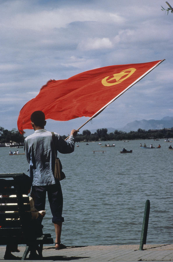 China, Beijing, Summer Palace, man waving flag, rear view Photograph by Seth Joel