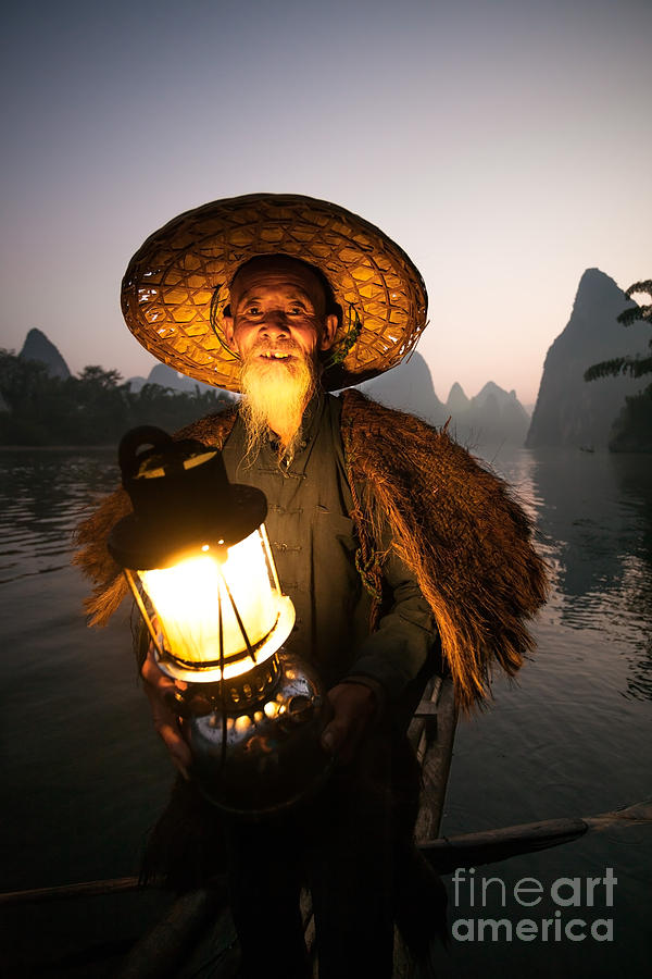 Chinese fisherman with lantern on boat near Guilin China Photograph by Matteo Colombo