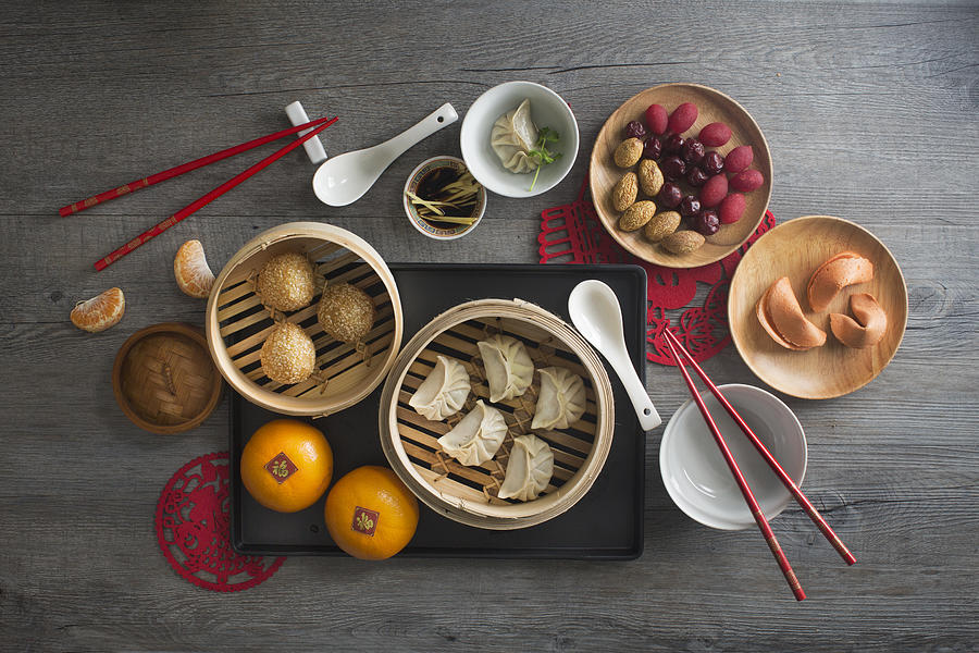 Chinese food steamed dumpling and tea served on rustic wooden background. Photograph by Twomeows