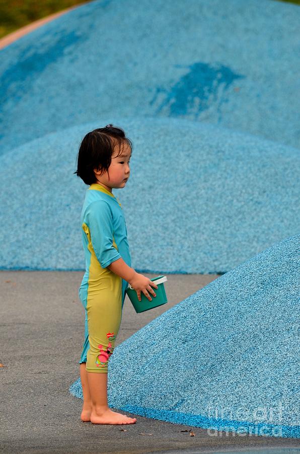 Chinese girl child plays with water in Singapore park Photograph by Imran Ahmed