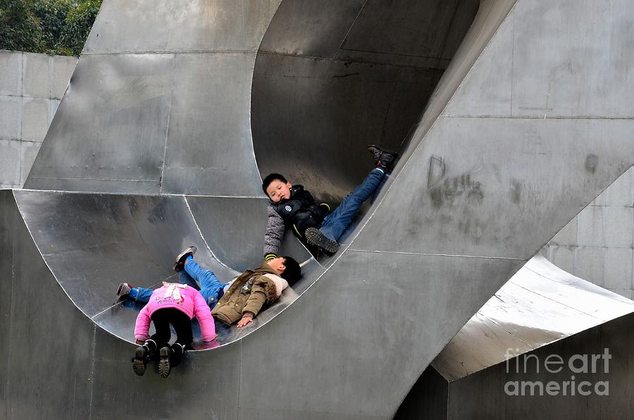 Chinese kids play in outdoor metal sculpture Shanghai China Photograph by Imran Ahmed