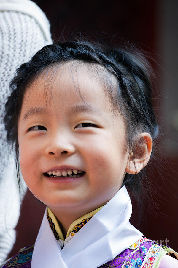 Chinese little girl in traditional dress smiling Photograph by Matteo Colombo