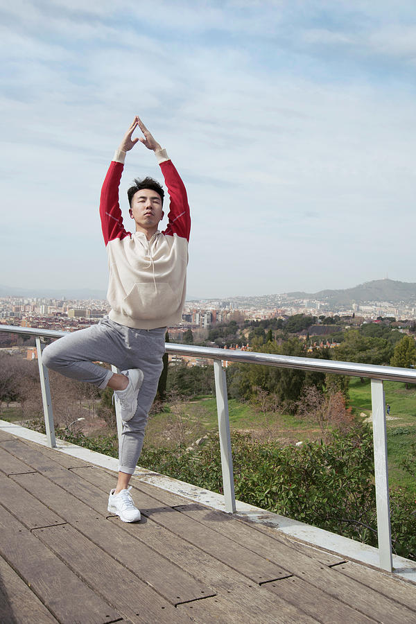 Nirvana Photograph - Chinese Man Doing Yoga In Vrksasana by Daniel Santacatalina
