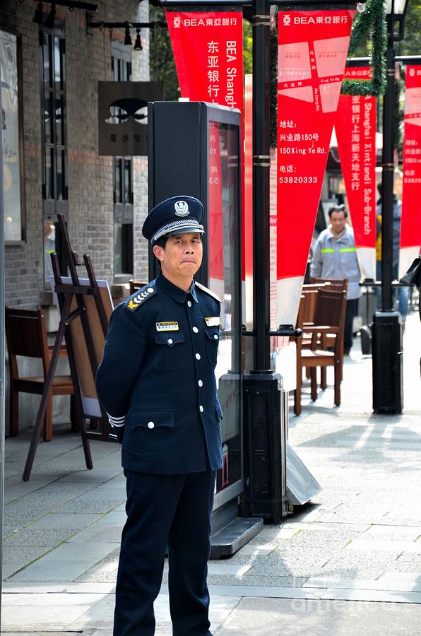 Chinese security guard stands alert Shanghai China Photograph by Imran Ahmed