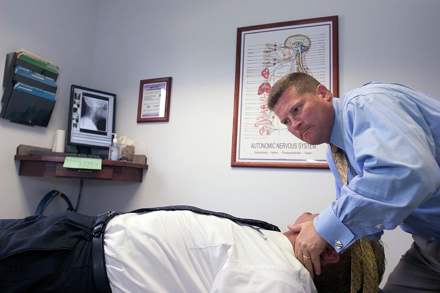 Chiropractic Photograph - Chiropractor Manipulating Patient by Jim West