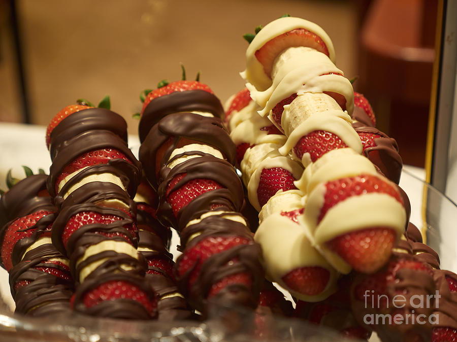 Chocolate coated strawberries and bananas on skewers Photograph by Louise Heusinkveld