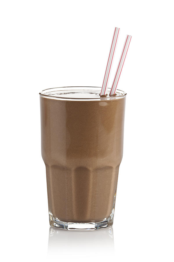 Chocolate milkshake glass against white background Photograph by Fcafotodigital