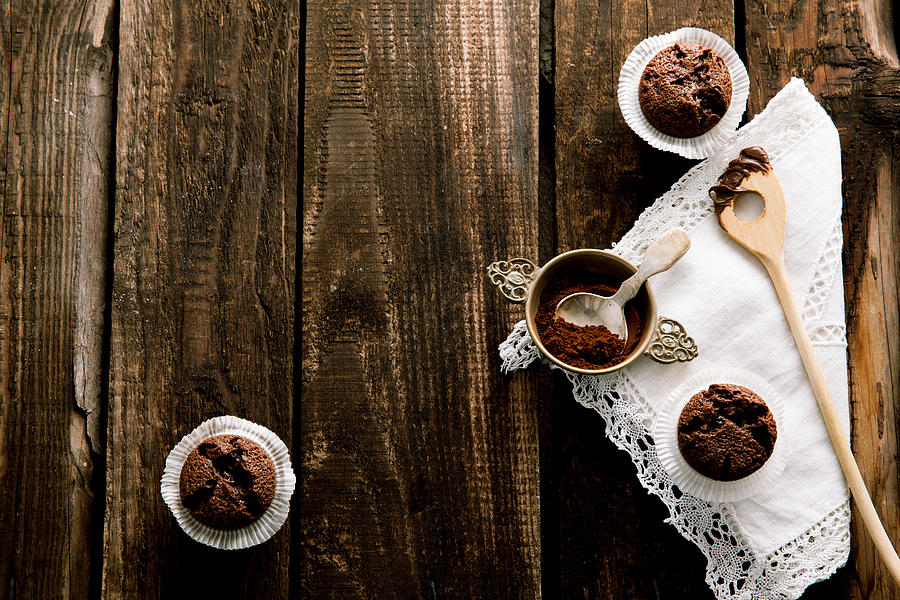 Chocolate muffin on dark wooden board Photograph by Carolafink