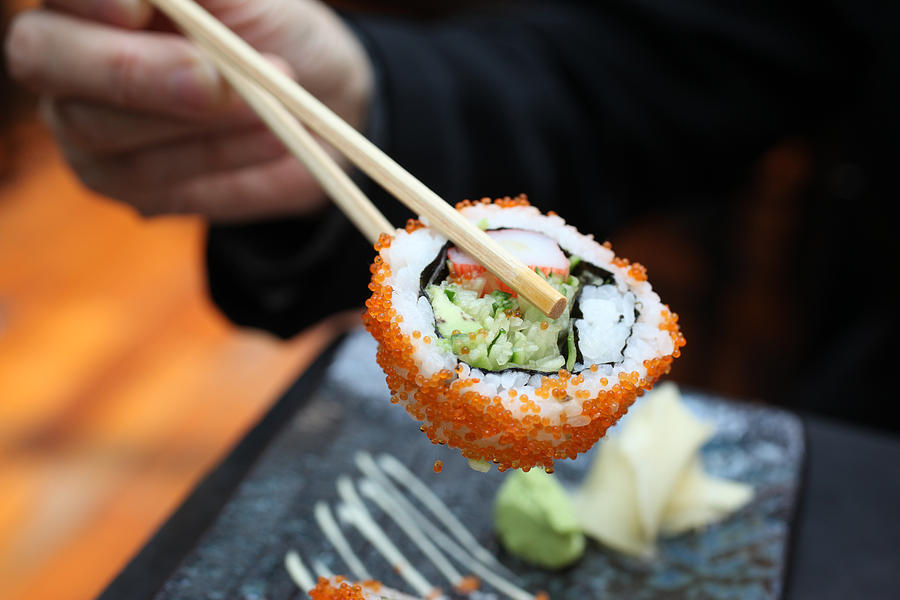 Chopsticks Holding Sushi Photograph by Harvey Tsoi