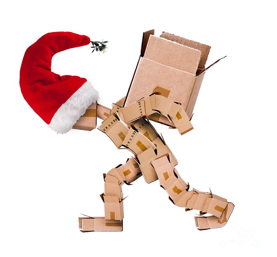 Christmas character carrying a large box  Photograph by Simon Bratt